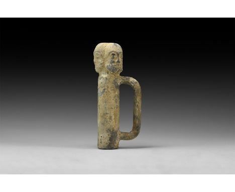 An undated archaistic tubular lead alloy finial with lateral strap handle, three radiating male faces above.  3.2 kg, 20.5cm 