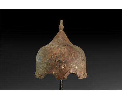 Late 19th-20th century AD. An iron helmet with ribbed dome, spike with polyhedral bulb and incised calligraphic text to the b