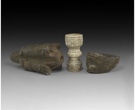 An undated archaistic group of three carved stone items including a boat-shaped oil lamp the sides with shallow relief animal
