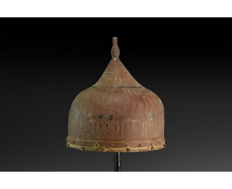 Late 19th-20th century AD. An iron helmet with ribbed dome, spike with polyhedral bulb and inlaid calligraphic text to the ba