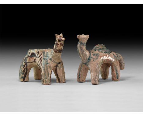 A pair of undated archaistic glazed ceramic animal figures, one with dorsal tray and lateral pinched panniers.  583 grams tot