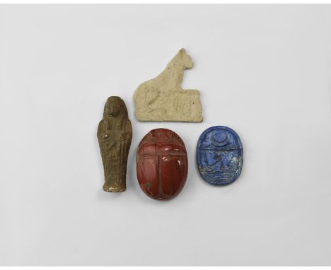18th-19th century AD. A mixed group comprising: a polished jasper(?) scaraboid; a lapis lazuli plaque with reserved hieroglyp