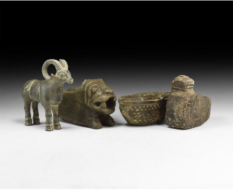 An undated archaistic group of carved stone items comprising: a scooped oil lamp with low-relief canine to each side; a spout