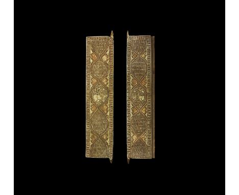 An undated archaistic pair of carved stone architectural panels with calligraphic text to the border and median arabesque pan
