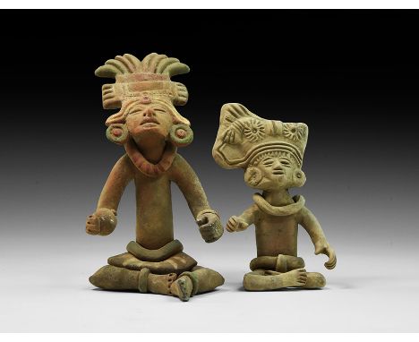 A pair of undated archaistic ceramic seated Teotihuacan-style figures; one with anklets, necklace, bracelets, skirt, earrings