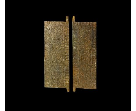 An undated archaistic pair of carved stone architectural panels with calligraphic text to the border and median arabesque pan