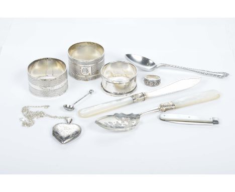 A collection of silver itemsTo include three napkin rings, teaspoon, heart shaped locket and chain, Mother of Pearl handled p