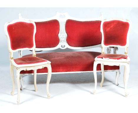 An Edwardian painted and upholstered sofa and two painted side chairsThe sofa with a pierced central splat flanked by two uph