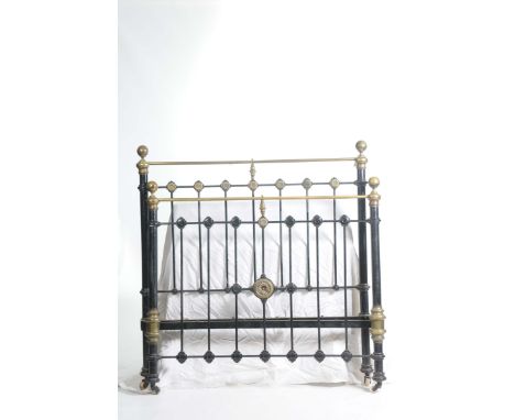 A Victorian painted iron and brass bed With brass spherical finials upon iron rails with brass flower head embellishments, co
