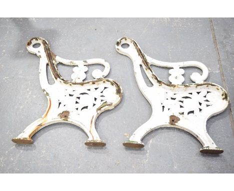 A pair of Victorian Coalbrookdale style painted iron bench supportsEach with a scroll terminal arm rest above a leaf and flow