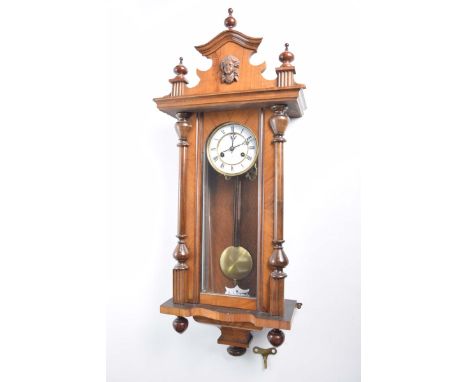 A Vienna wall clock late 19th Century14cm White enamel dial with Roman numerals, maker Junghans, with glazed door, and orname