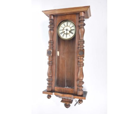 A Vienna wall clock late 19th Century18cm Cream enamel dial with Roman numerals, case with turned wood decoration, height 99c