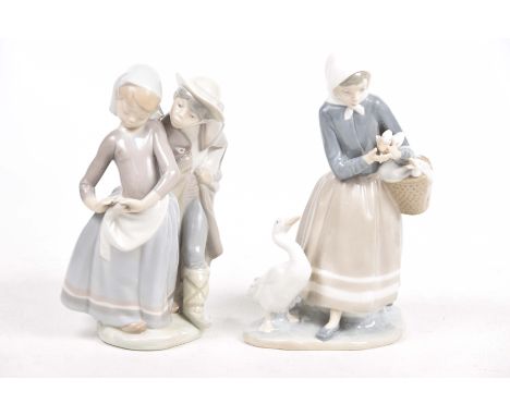 Two Lladro groupsThe first modelled has a young girl holding a basket with ducklings, the second with a young boy wearing a c