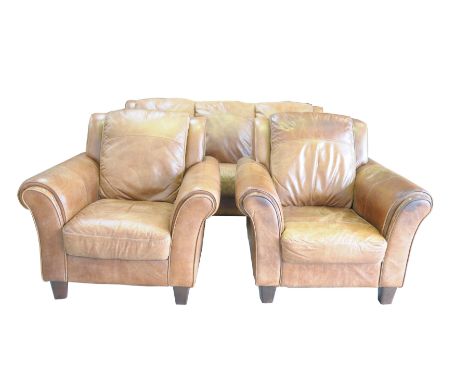 A good quality tan leather three piece lounge suiteHaving fixed padded cushion backs and seats flanked by padded scroll arms 