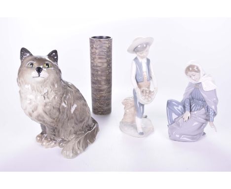 Two Nao figurinesComprising boy holding a basket of eggs, kneeling lady, Beswick model of a seated cat and a Broste vase (4)