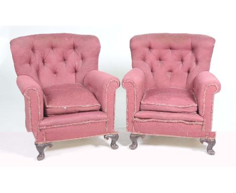 A pair of late 19th early 20th Century fireside armchairsEach with a button back, padded scroll arms and loose cushion seat r