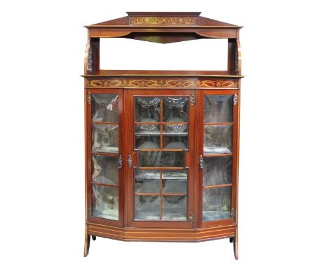 An impressive inlaid mahogany Art Nouveau display cabinet, early 20th CenturyThe architectural pediment inlaid with stylized 