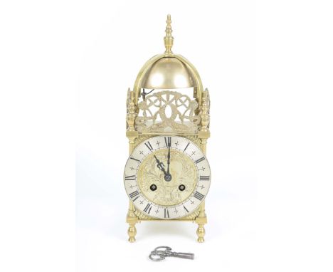 A good quality French made copy of an English 17th Century brass lantern clock, mid 20th Century The 11.5cm silvered dial wit