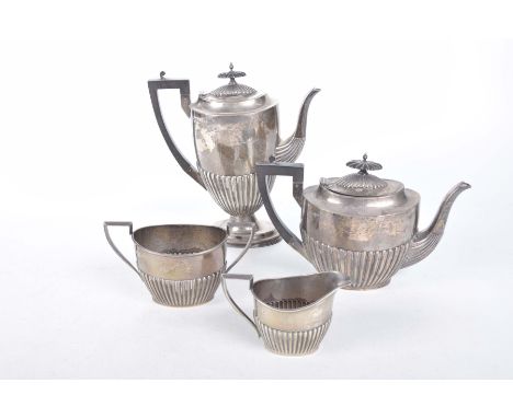 An Edward VII/George V hallmarked silver four piece tea and coffee set in the Georgian taste, by Walker and HallComprising a 