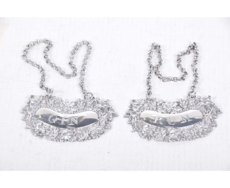 A matched pair of George IV hallmarked silver decanter labelsThe first example marked for Rum and decorated with embossed vin