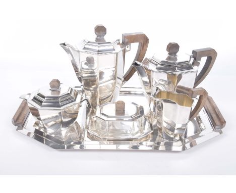 An Art Deco silver plated six piece tea setComprising a teapot with wooden finial and handle, a hot water pot with wooden fin