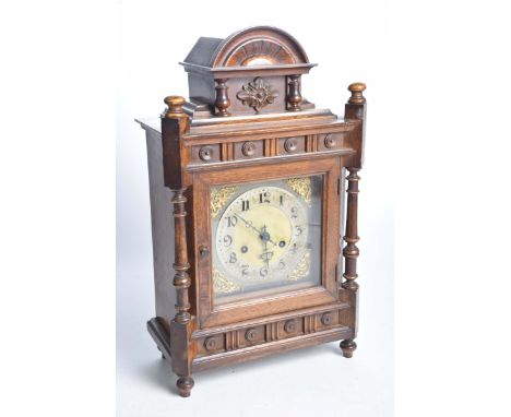 An oak cased mantel clock early 20th Century14cm Silvered dial with Arabic numerals, gilt metal spandrels, coiled chime, heig