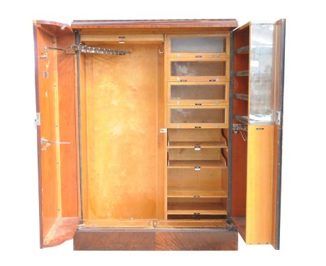 An early 20th Century mahogany "Compactum" gents fitted wardrobeThe caddy top above a pair of plain doors with openwork swing