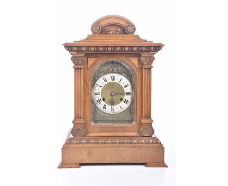 A walnut cased bracket clock late 19th early 20th CenturyWith 13cm silvered dial with Roman numerals, brass back plate, the m