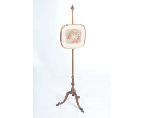 A mid 19th Century mahogany pole screenWith a leafy fruit finial above a gilt framed needlework panel the pole within a carve