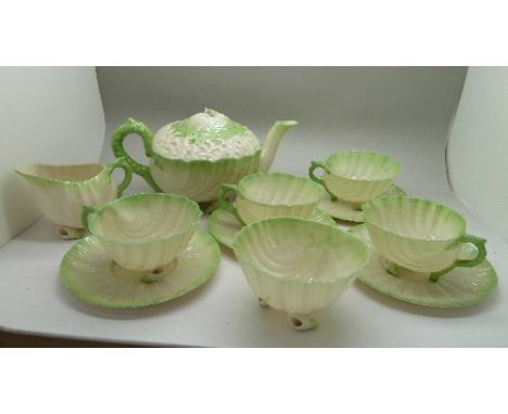 A Belleek Neptune green tea service comprising four cups and saucers, a sugar bowl, teapot and milk jug, teapot lid, a saucer