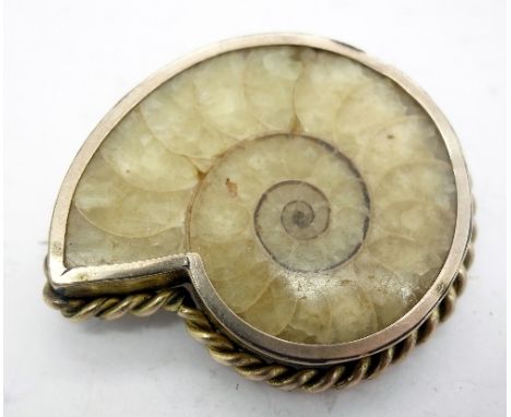 A plated fossil brooch