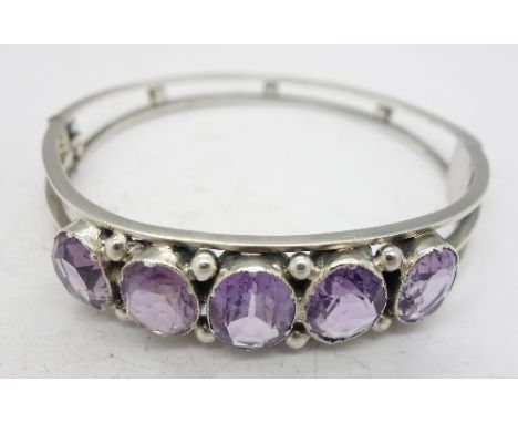 A silver and amethyst bangle