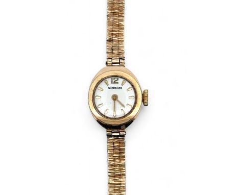 A Garrard ladies 9ct gold watch with 9ct gold bracelet. Inscribed to back of case 'For Dunlop service A. E. March'. Watch is 