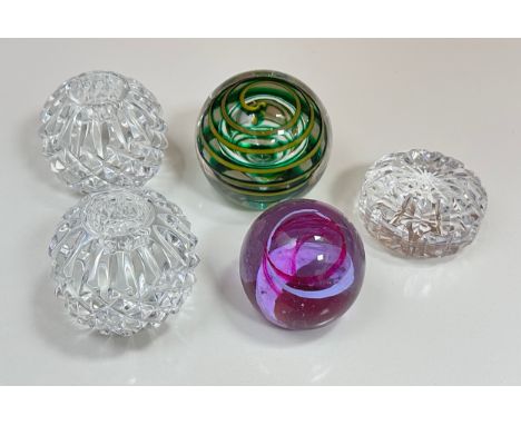 A pair of Waterford Crystal Lismore candle holders, both signed to base, a Caithness pastel paperweight, a green and yellow s