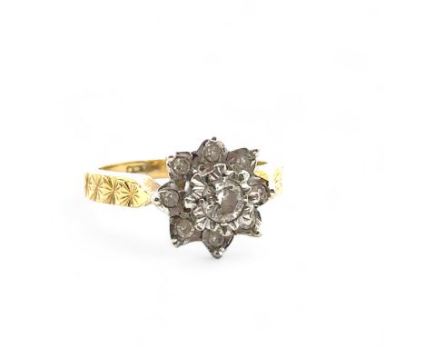 An 18ct yellow gold and diamond flower ring, size I. Central diamond of approx 0.2ct is illusion set in a white gold mount an