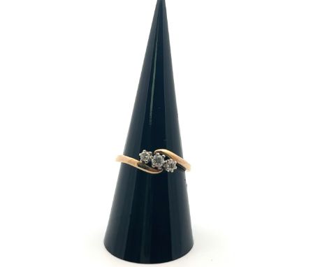 A 9ct three stone diamond crossover ring, size O. Sponsor RG. Estimated total diamond weight 0.2ct. Weight 2.83g. Dinks to sh