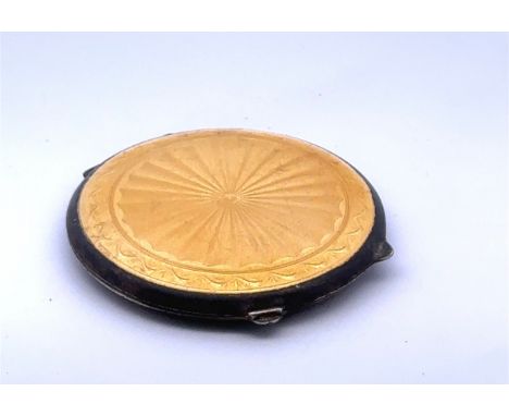 A yellow guilloche enamel silver compact by Joseph Gloster, Birmingham 1946. Complete with powder puff. No chips to enamel bu