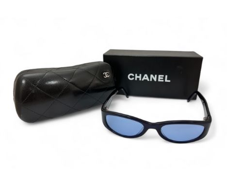 A pair of navy Chanel Sunglasses with blue tinted lenses. In a quilted Chanel box and with outer box.. Used with some light s