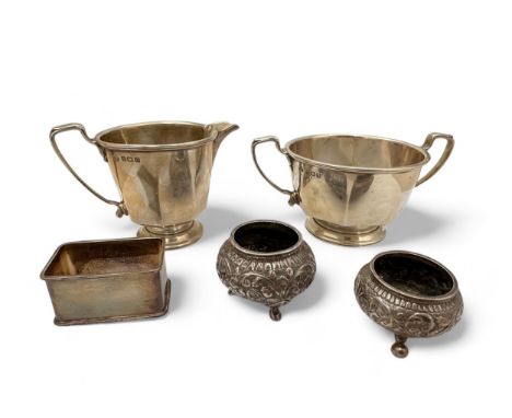 An octagonal cream jug and sugar bowl with marks for Adie Brothers, Birmingham 1933. With a rectangular silver napkin ring an