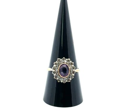 An amethyst and diamond oval cluster ring, the amethyst with double border of diamonds, in a 9ct gold mount, size R. Amethyst