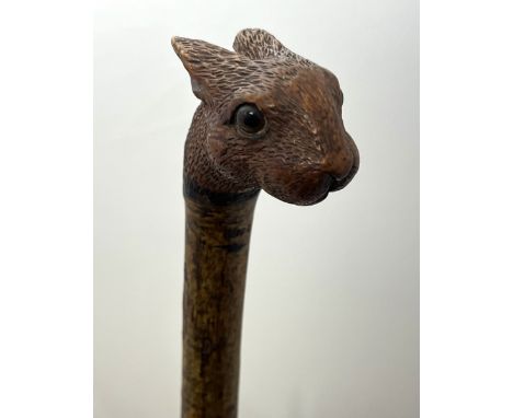 A Brigg carved squirrel head walking stick with glass eyes, stamped Brigg. Length 92cm.