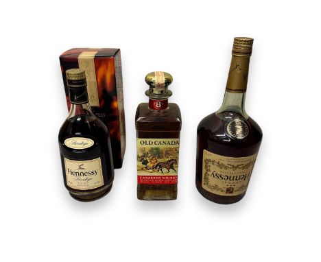 Two Bottles Of Hennessy Cognac &amp; A Bottle Of Old Canada Whisky. One 70cl bottle of Hennessy Privilege V.S.O.P Cognac, sea