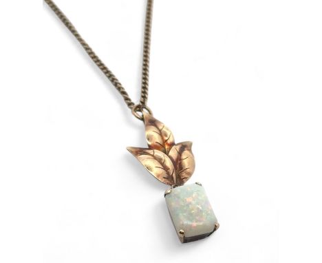 An opal drop pendant necklace on a 22" hallmarked 9ct gold chain. Octagonal cut opal cabochon of approx 11mm x 8mm, suspended