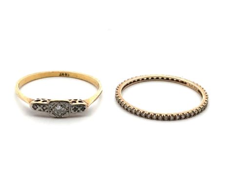 Two white stone rings. A vintage diamond ring stamped 18ct size U and a CZ eternity ring stamped 375 size V. Combined weight 