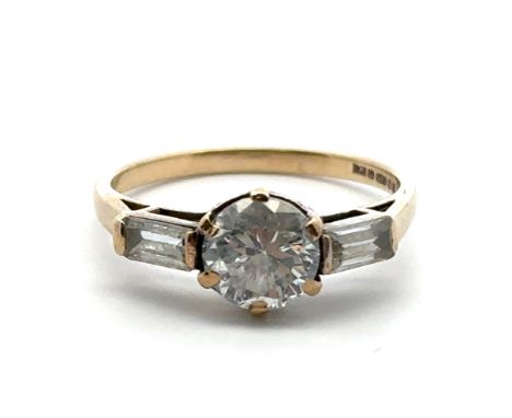 A 9ct gold ring set with a central round cut CZ between two baguette cut CZs. Size N. Weight 2.12g