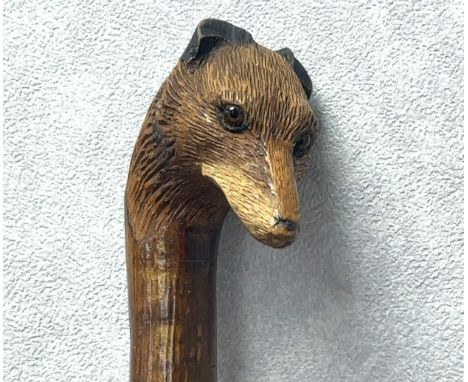 A walking stick with the handle carved with the head of a fox with glass eyes, in the style of Swaine &amp; Adeney. Length ap