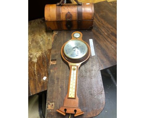 A BAROMETER AND A LEATHER TREASURE CHEST.