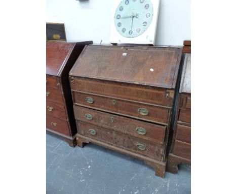 A GEORGE III MAHOGANY BUREAU, THE OAK BANDED FALL ENCLOSING A WELL ABOVE THREE GRADED LONG DRAWERS AND BRACKET FEET.   