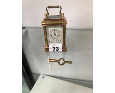 A MINIATURE BRASS CASED CARRIAGE CLOCK WITH TRIPLE DIAL. 