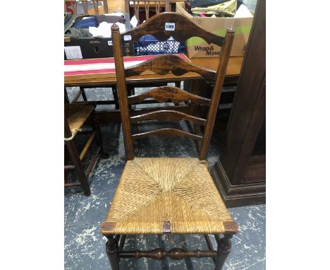 A PAIR OF LADDER BACKED CHAIRS WITH RUSH SEATS, THE TURNED FRONT LEGS ON PAD FEET